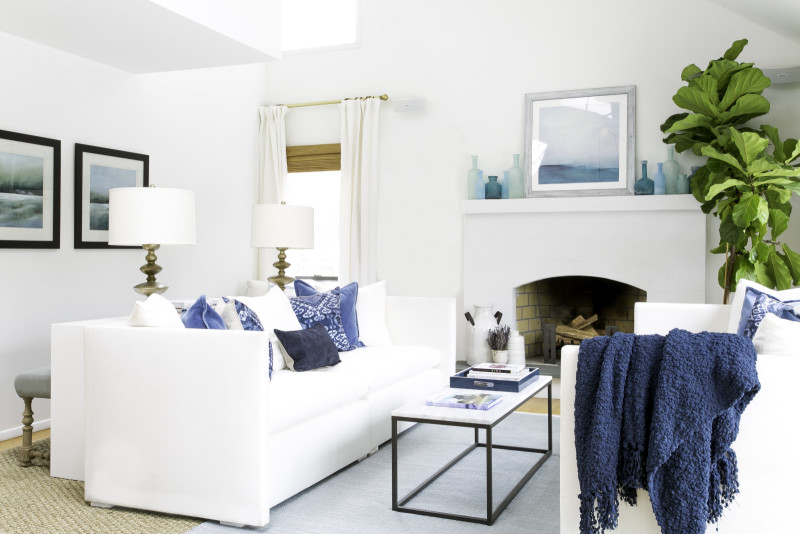 All white furniture creates a spring vibe in a living room. Photo via Laurel & Wolf.